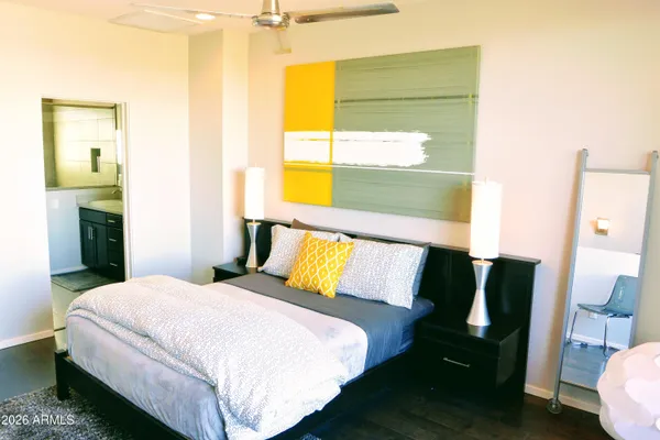 a bedroom with a bed and wooden floor