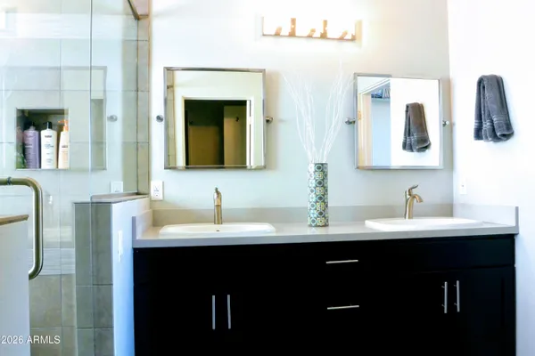 a bathroom with a double vanity sink and mirror