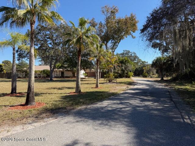 1201 Northeast Tropicana Road Palm Bay, FL 32905 - Photo 8 of 23 a view of road with trees