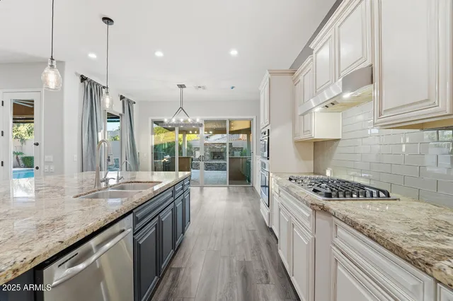 a kitchen with stainless steel appliances granite countertop a lot of counter top space and cabinets