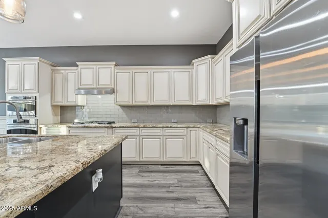 a kitchen with a stove oven and white cabinets
