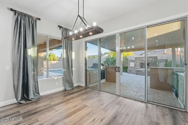 a large kitchen with stainless steel appliances granite countertop a lot of cabinets and wooden floor