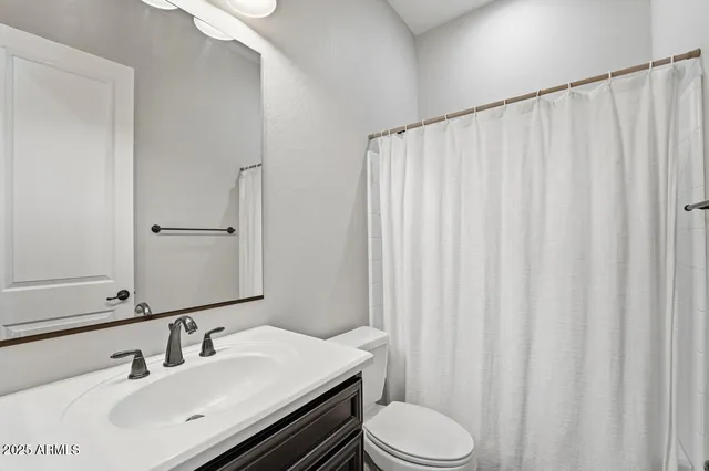 a view of a hallway with wooden floor and closet area