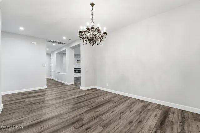 a kitchen with kitchen island granite countertop a large center island and stainless steel appliances