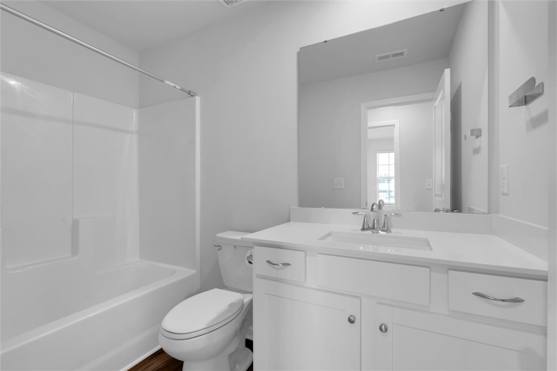 515 Brasstown Court Pendleton, SC 29670 - Photo 16 of 25 This bright bathroom features a pristine vanity and a practical shower-tub combination.