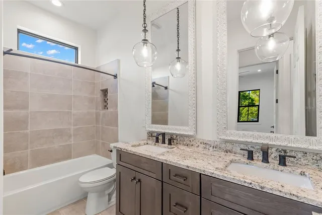 a large kitchen with cabinets and wooden floor