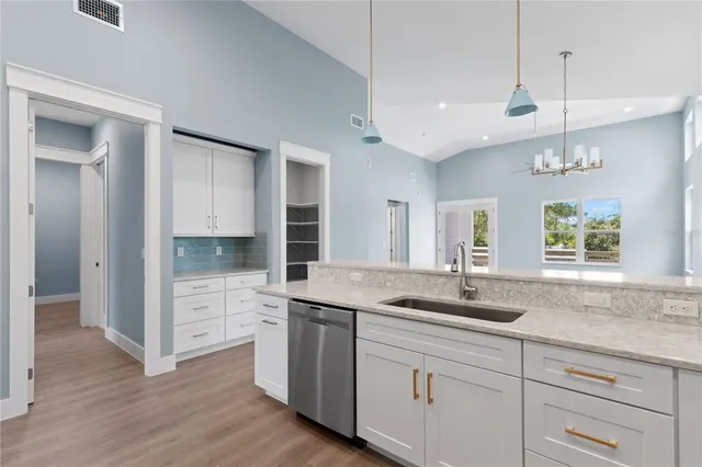 a view of a kitchen with a sink and cabinet