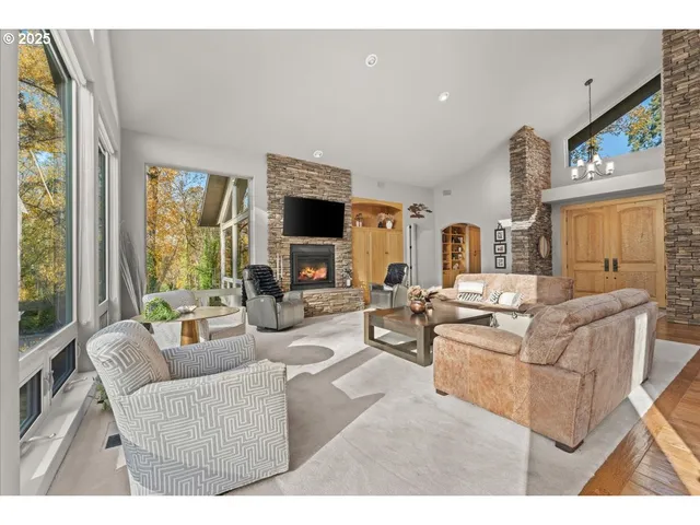 a view of a patio with table and chairs and couches with wooden floor
