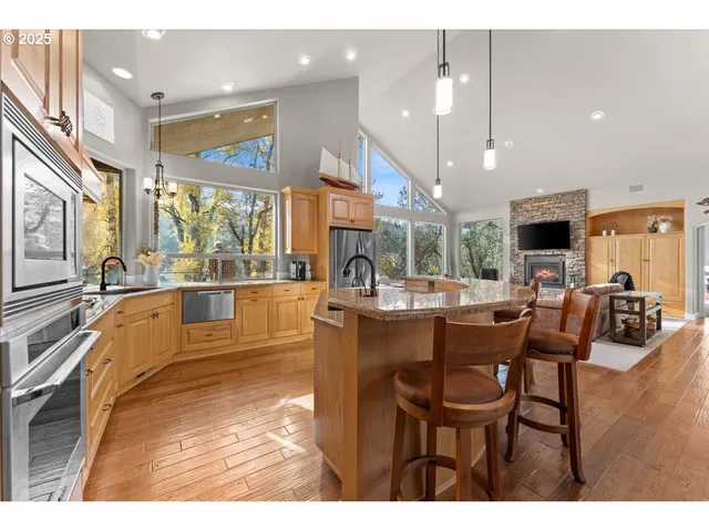 a view of a dining room with furniture a chandelier and wooden floor