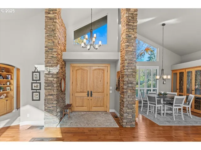 a living room with furniture a flat screen tv and a floor to ceiling window