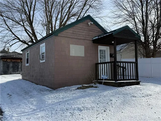 a view of backyard with small cabin and wooden fence