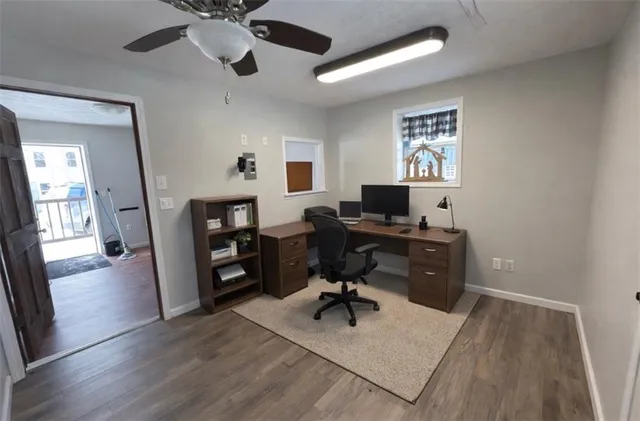 a view of a workspace with furniture and a window