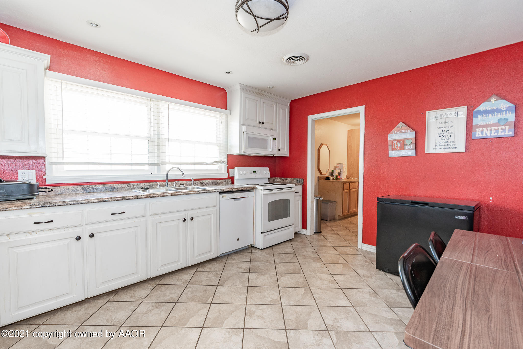 4610 South Rusk Street Amarillo, TX 79110 - Photo 3 of 22 a kitchen with a sink cabinets and window