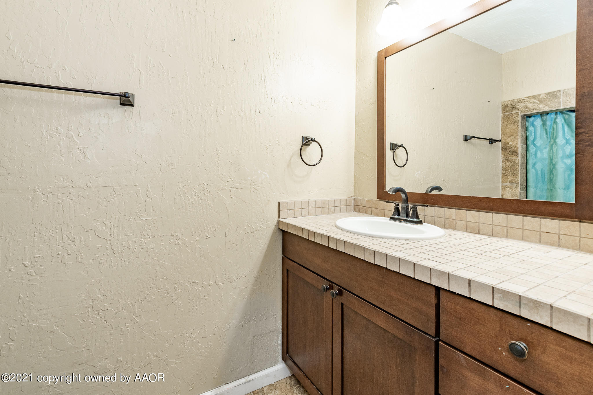 4610 South Rusk Street Amarillo, TX 79110 - Photo 9 of 22 a bathroom with a granite countertop sink and a mirror