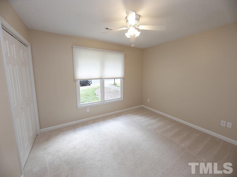 6400 Meadow View Drive Raleigh, NC 27609 - Photo 12 of 17 an empty room with windows and fan