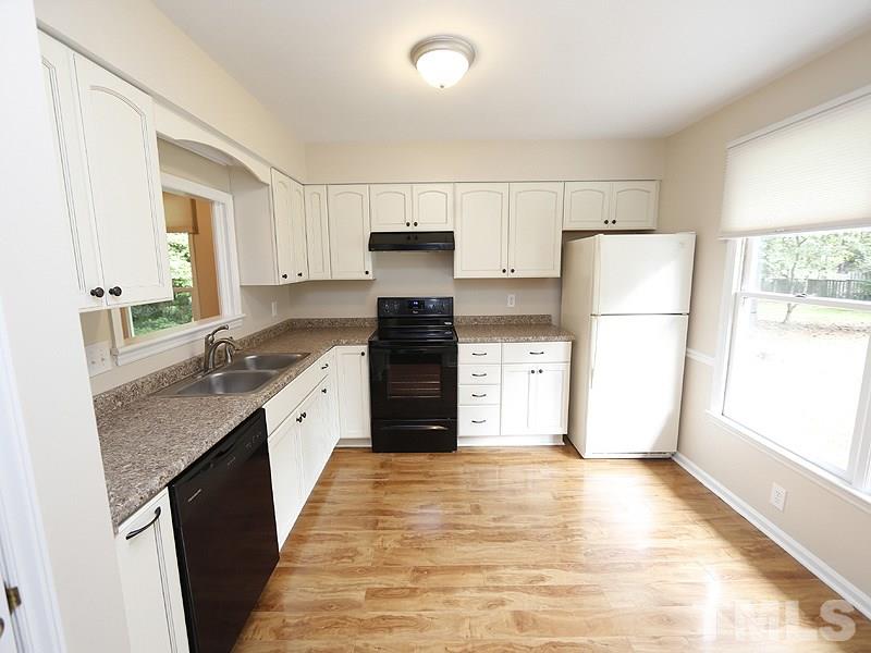 6400 Meadow View Drive Raleigh, NC 27609 - Photo 14 of 17 a kitchen with a refrigerator a sink and a stove