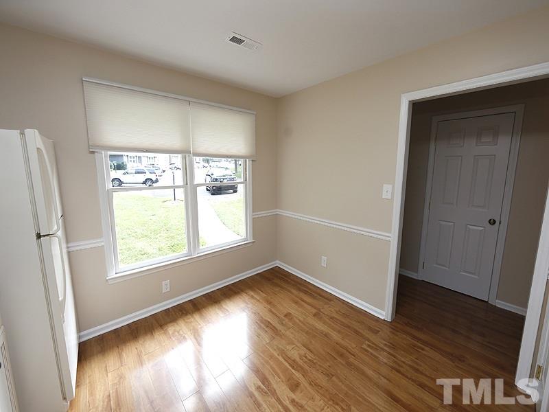 6400 Meadow View Drive Raleigh, NC 27609 - Photo 5 of 17 an empty room with wooden floor and windows