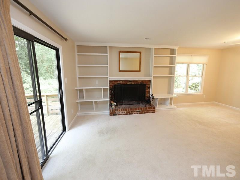6400 Meadow View Drive Raleigh, NC 27609 - Photo 7 of 17 an empty room with windows and a fireplace