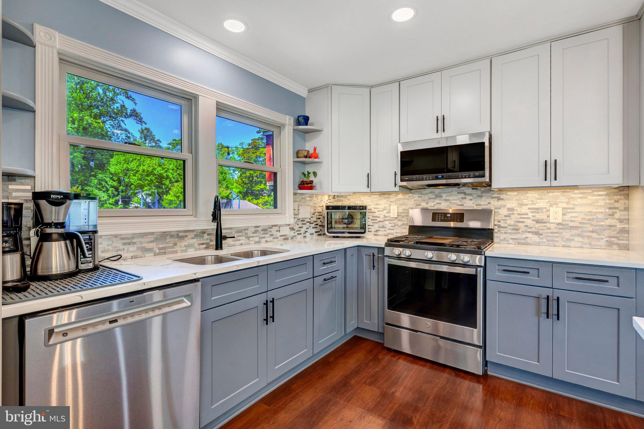 7212 Galgate Drive Springfield, VA 22153 - Photo 7 of 39 a kitchen with stainless steel appliances granite countertop a sink stove and microwave