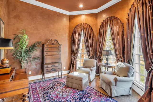 a living room with furniture fireplace and window
