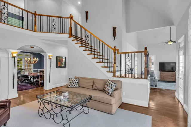 a living room with stainless steel appliances kitchen island granite countertop furniture and a fireplace