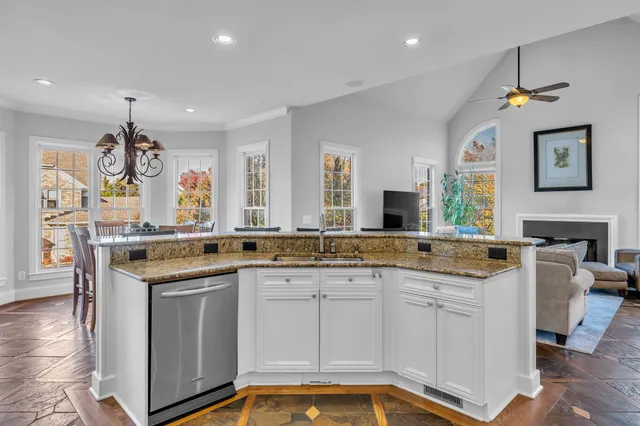 a spacious bedroom with a bed and a chandelier