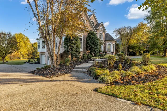 a front view of a house with swimming pool and sitting area