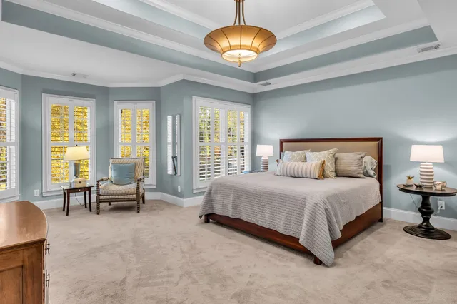 a bedroom with a bed and a chandelier