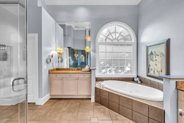 a bedroom with a bed and a dresser next to a window