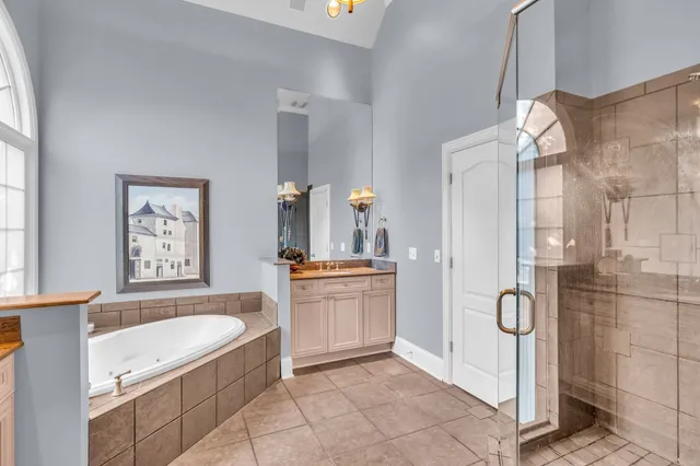 a bathroom with a granite countertop sink mirror and shower