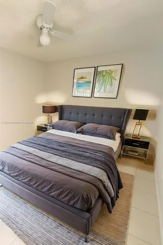 a bedroom with a bed and a painting on the wall