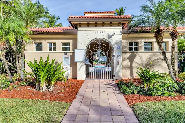 a view of a house with a small yard and plants