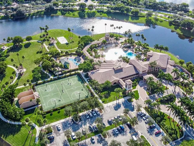 an aerial view of a house with a garden and lake view