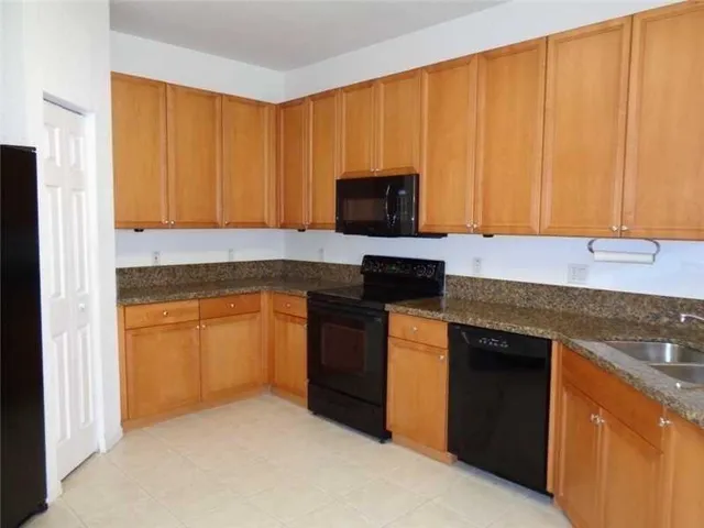 a kitchen with a sink stove and microwave