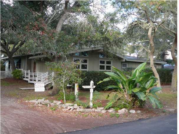 58 Garfield Street Santa Rosa Beach, FL 32459 - Photo 1 of 20 a front view of a house with garden