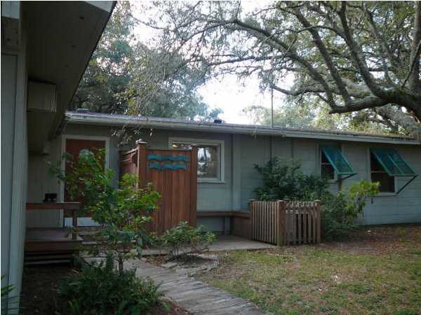 58 Garfield Street Santa Rosa Beach, FL 32459 - Photo 2 of 20 a view of a house with a yard plants and large tree