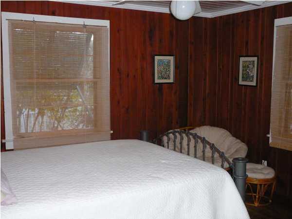 58 Garfield Street Santa Rosa Beach, FL 32459 - Photo 10 of 20 a bedroom with a bed and wooden floor