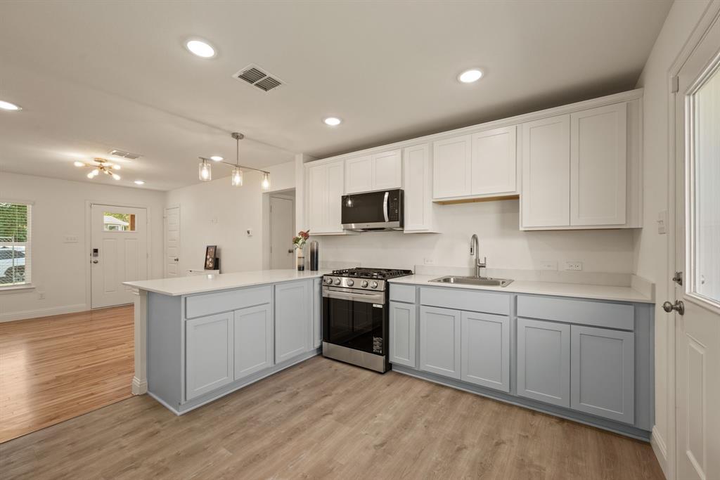 4096 Merida Avenue Fort Worth, TX 76110 - Photo 7 of 17 Sleek stainless steel and black appliances include Gas Range and Microwave; Under sink is prewired for a disposal