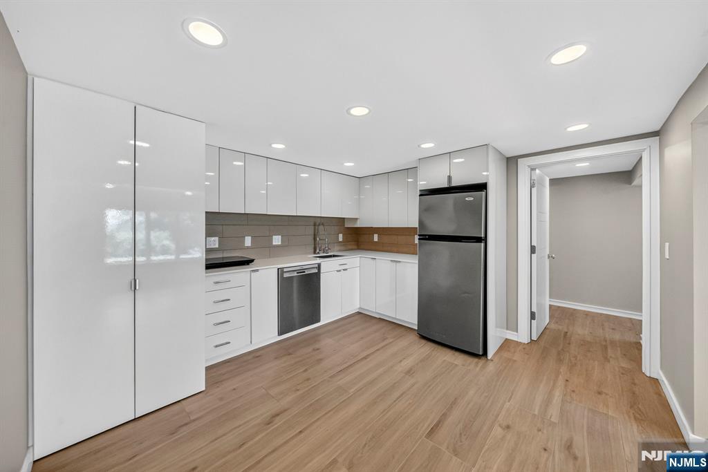 57 Hemlock Road Little Falls, NJ 07424 - Photo 36 of 50 a kitchen with a refrigerator a sink and cabinets