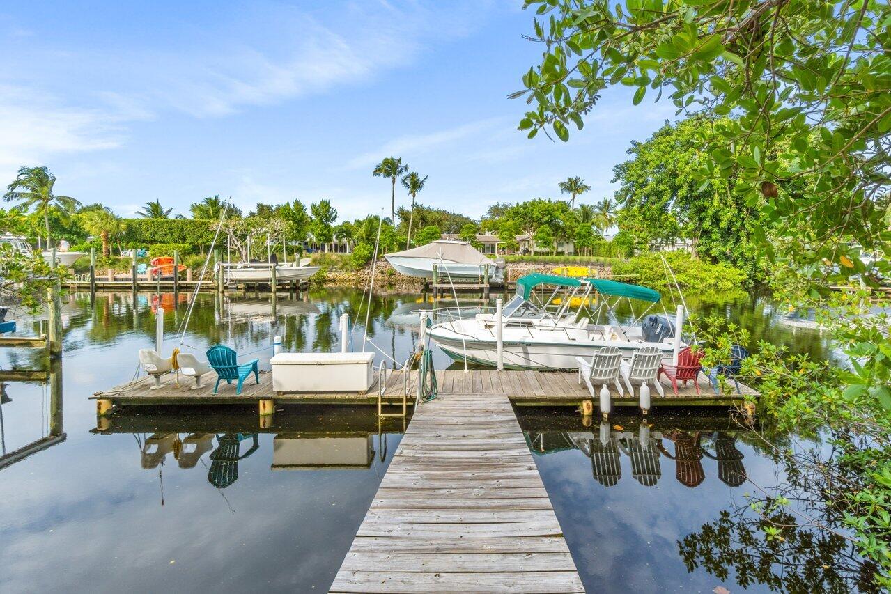 a roof deck with table and chairs potted plants with large trees