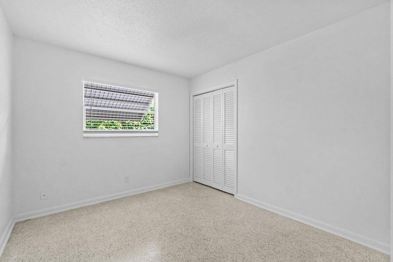 751 Hummingbird Way, Unit 7 North Palm Beach, FL 33408 - Photo 16 of 40 an empty room with windows