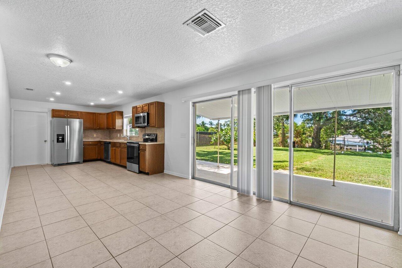 751 Hummingbird Way, Unit 7 North Palm Beach, FL 33408 - Photo 9 of 40 a view of kitchen with furniture and large window