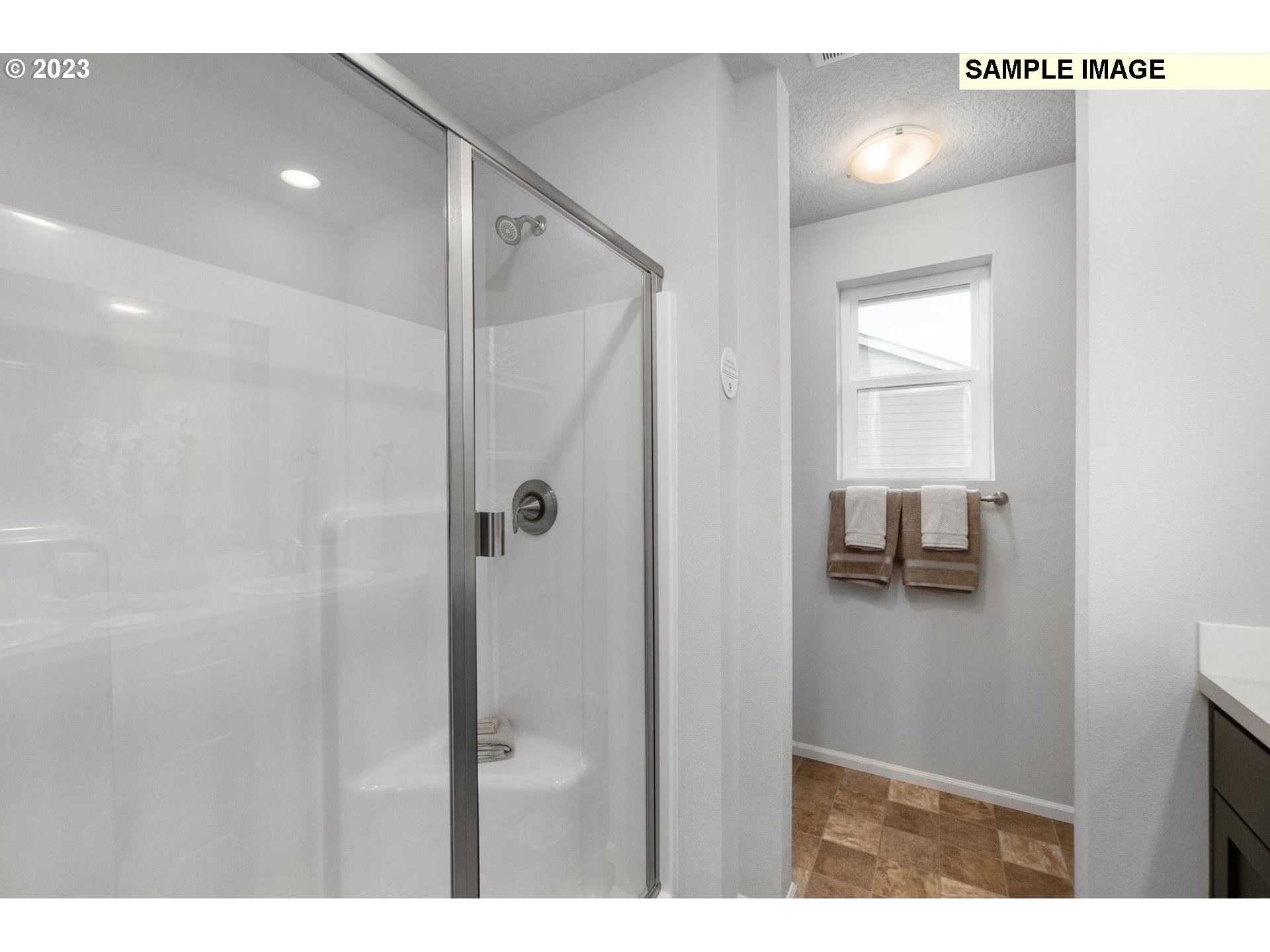 1058 Clemson Street Gervais, OR 97026 - Photo 11 of 20 a bathroom with a shower and a sink