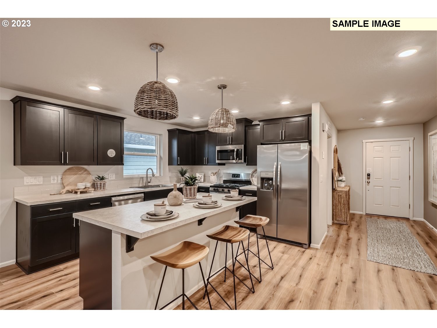 1058 Clemson Street Gervais, OR 97026 - Photo 3 of 20 a kitchen with stainless steel appliances kitchen island granite countertop a refrigerator and a stove top oven
