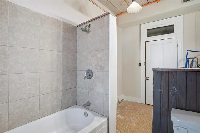 a bathroom with a tub and shower