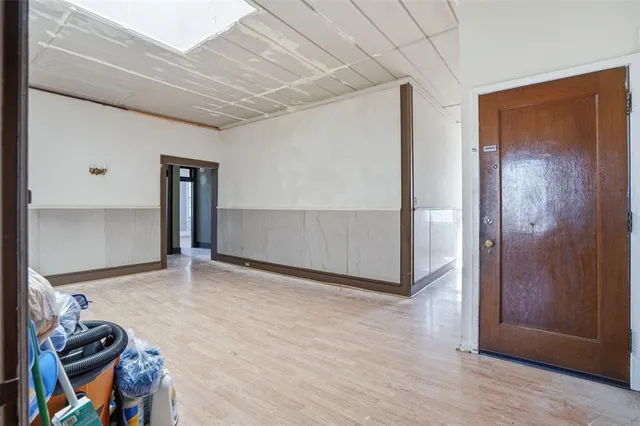 a view of a room with wooden floor and windows