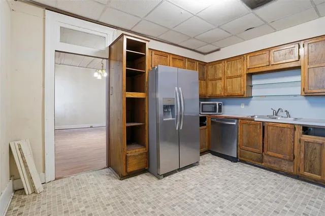 a kitchen with stainless steel appliances granite countertop a refrigerator sink and cabinets