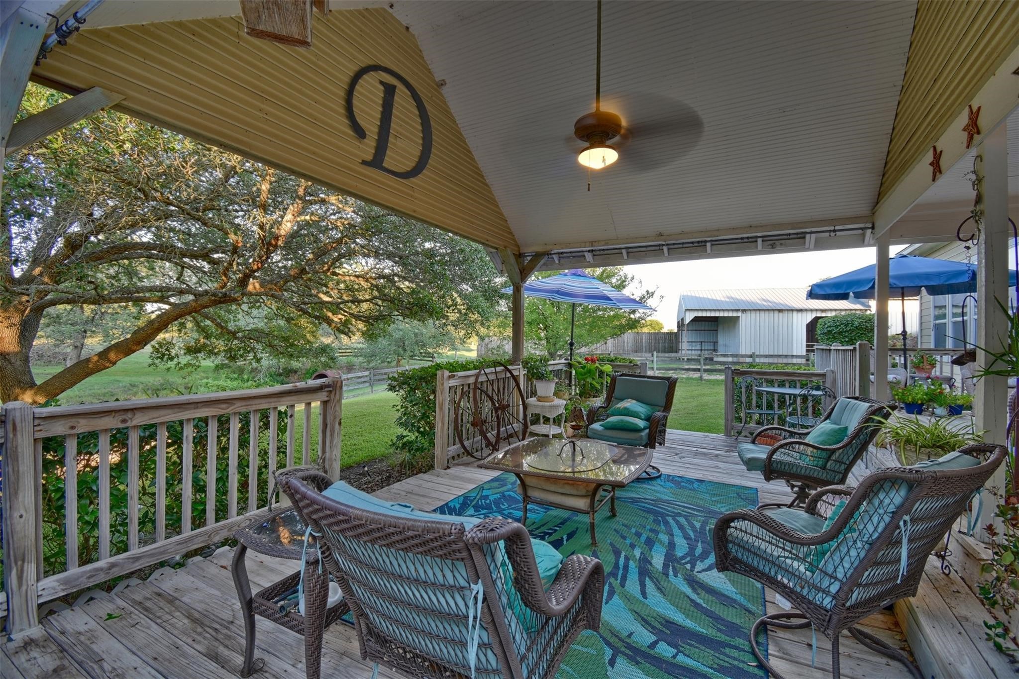8456 Schuster Road Ledbetter, TX 78946 - Photo 39 of 49 a view of a patio with a dining table and chairs with wooden floor