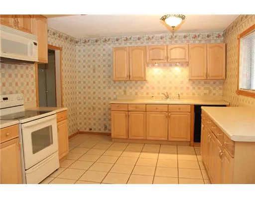 a kitchen with a sink cabinets and appliances