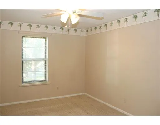 a view of a room with window and a ceiling fan